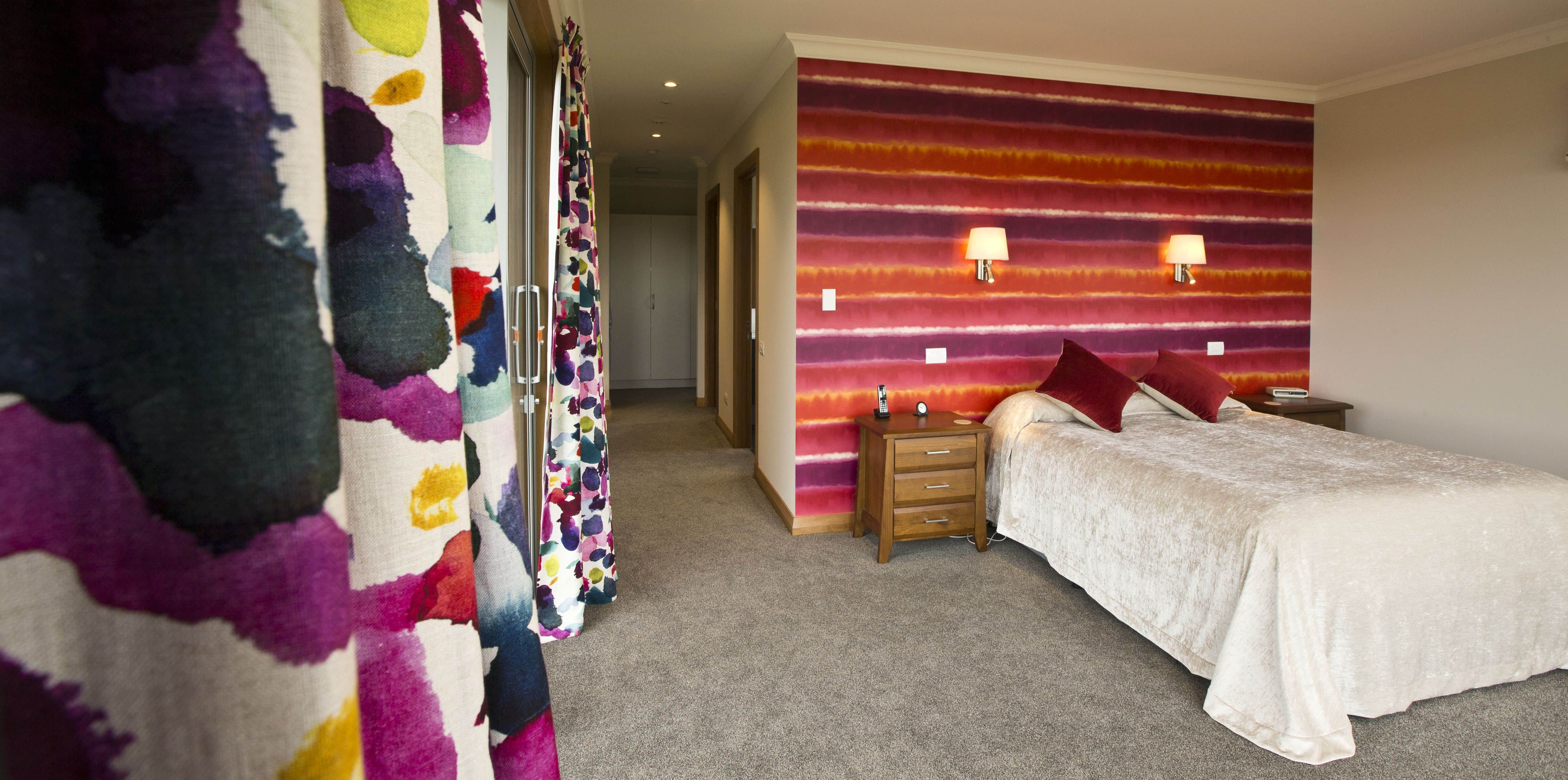  The main bedroom from another angle to show off the vibrant wallpaper