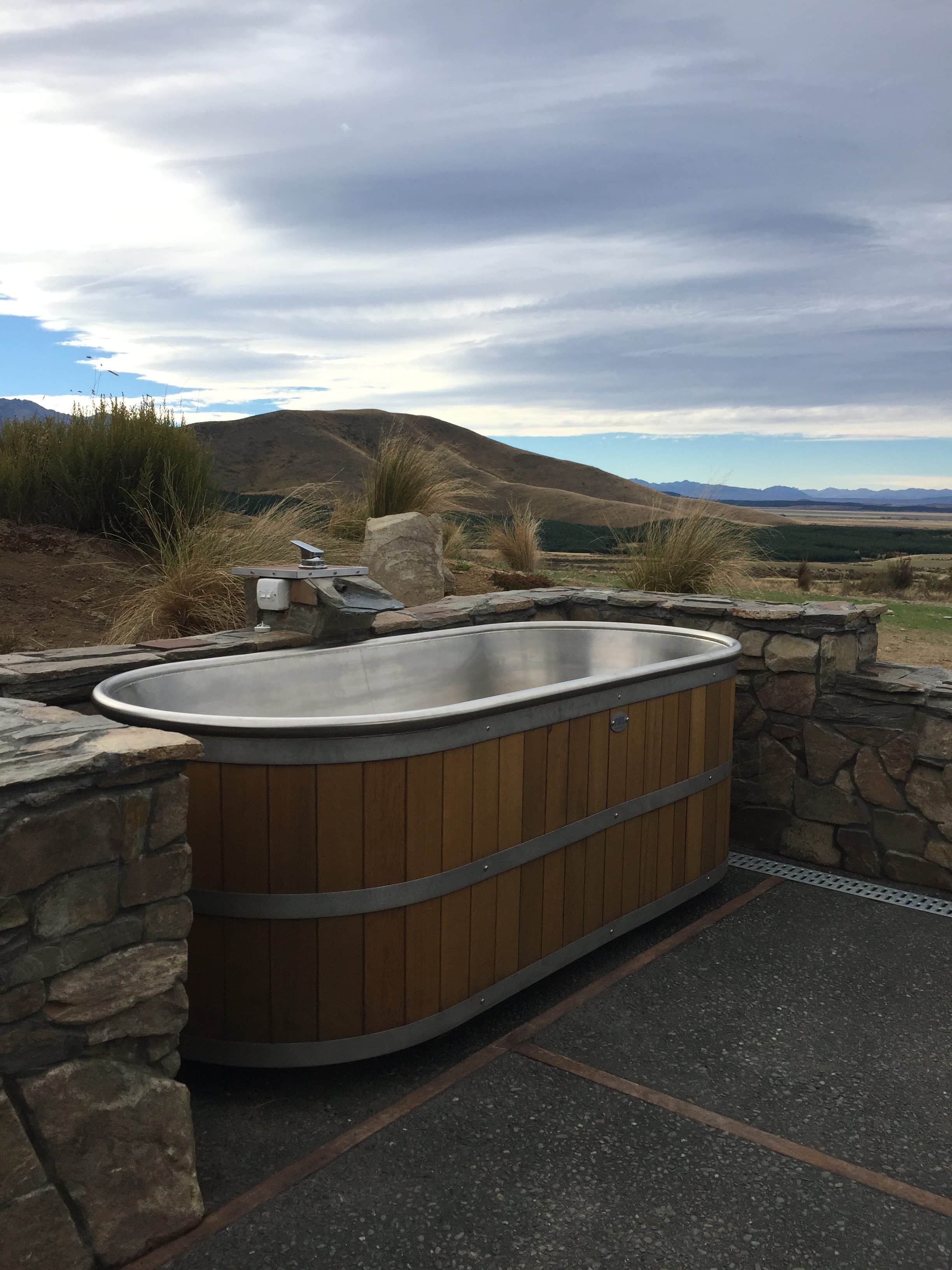  "Soak" stainless steel bath with its cedar sides fits perfectly into the natural landscape