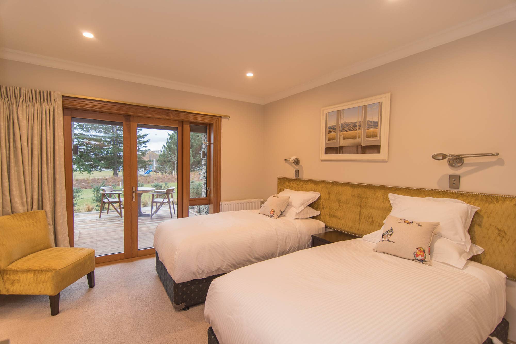 King single beds in this guest bedroom add extra comfort for a weary traveler  Gingko leaves look give an added point of interest to this En suite  The wool bale stencil names each individual room.  Once of the 3 guest bedrooms of this lodge  A merino fle