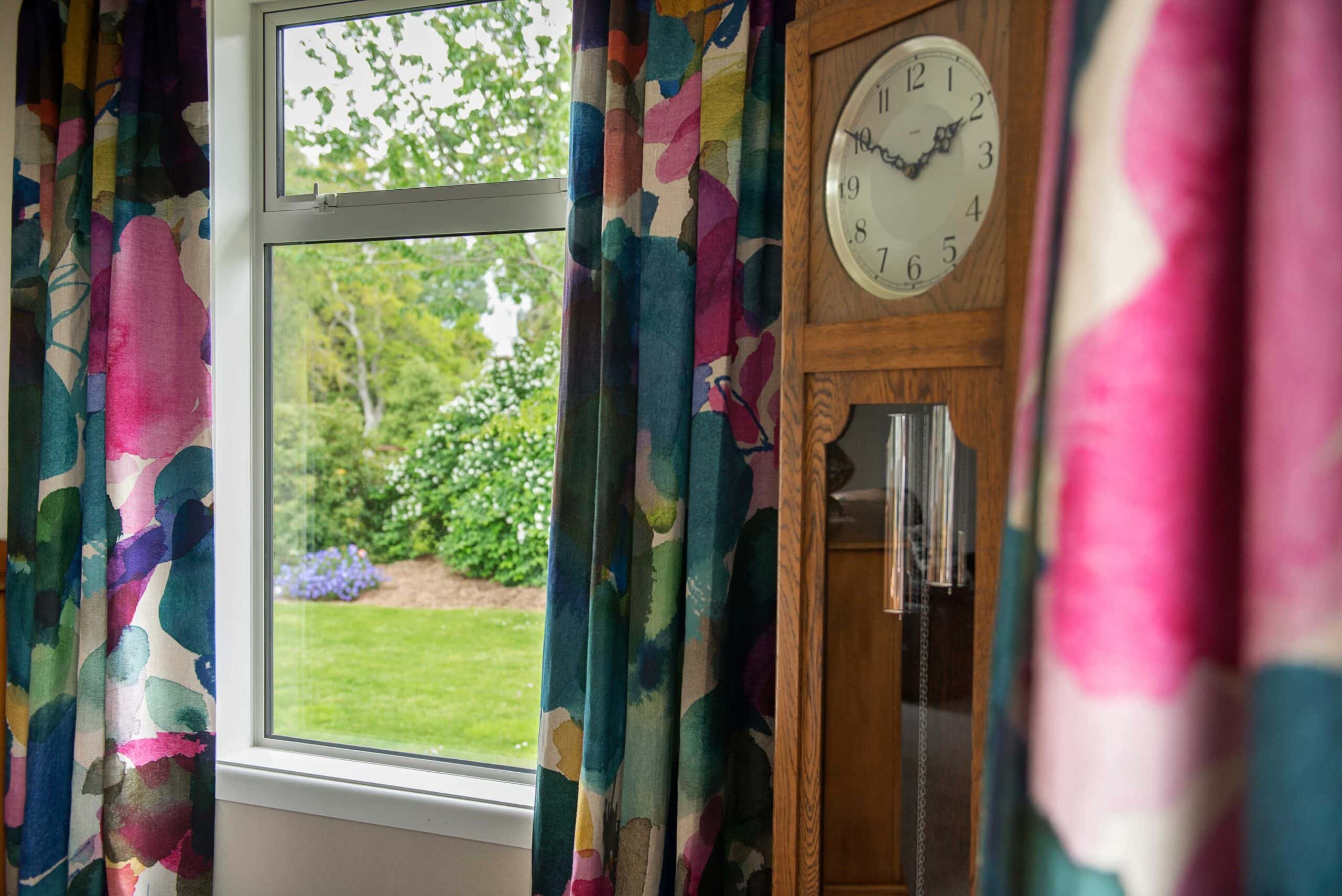 Bluebellgray curtains frame the beautiful garden outside