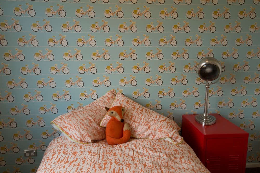 Mr fox bedroom with cycle wallpaper as a feature 