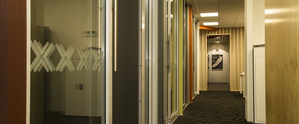 The hallway with coloured feature walls in each room